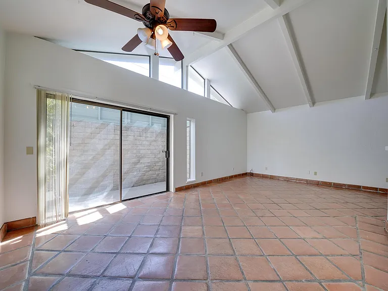 Living room. Vaulted ceilings. Fresh paint throughout the house. Satillo tile will make you feel like you're in Mexico (or Napa valley). Sliding door to front patio area.