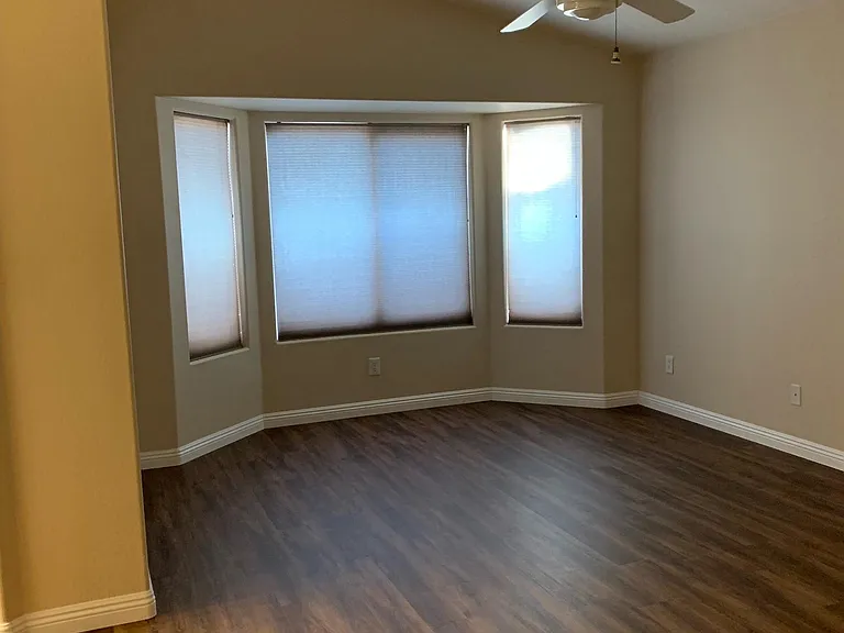 Spacious master bedroom with vaulted ceilings, luxury vinyl plank flooring, bay window and lots of natural light.