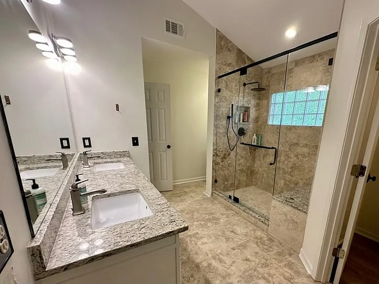 Primary Bathroom with large shower with shower bench. Private toilet room. Large walk-in closet.