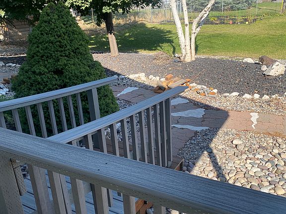 This photo is from the back porch. The green grass is in the yard as well as a garden spot (black plastic) at back.