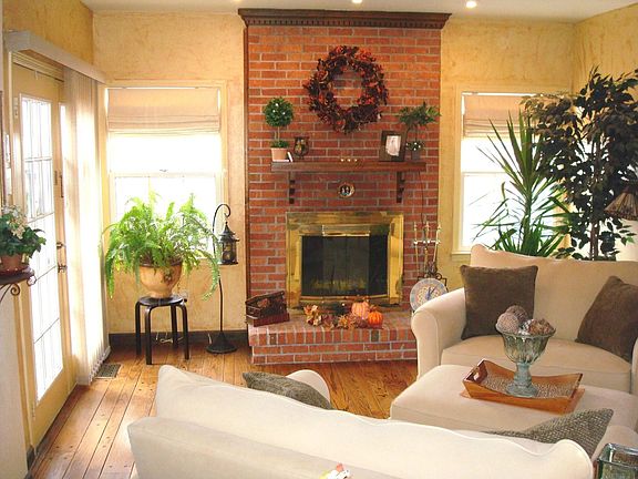 Family Room - hardwood floor, brick fireplace, french doors & ceiling fan.