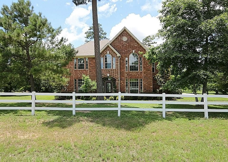Fabulous 2-story home sits on 1.7 acres in the wooded gated community of Grand Lake Estates.