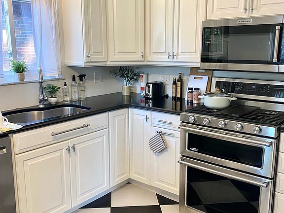 Recently updated kitchen with double oven, gas stove top, microwave, dishwasher, and fridge + freezer.