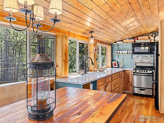 Fully functional adorable kitchen with appliances, fully stocked, Has a garbage disposal, large sink, microwave, toaster oven and gas range.