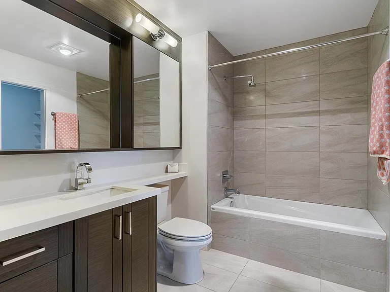 Tile Bathroom with spacious quartz vanity