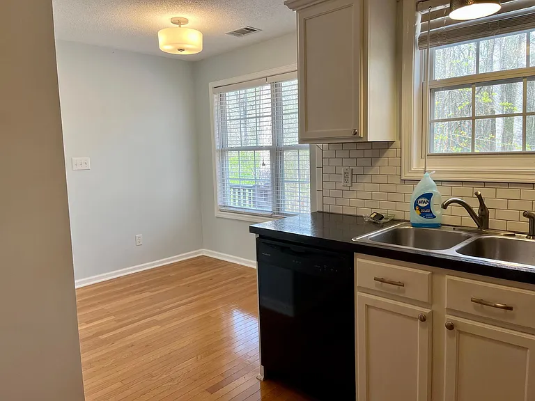 Kitchen leads into a breakfast nook area.