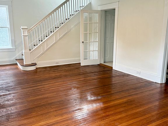 Living room with staircase leading to second floor with 3 bedrooms, bathroom, laundry room