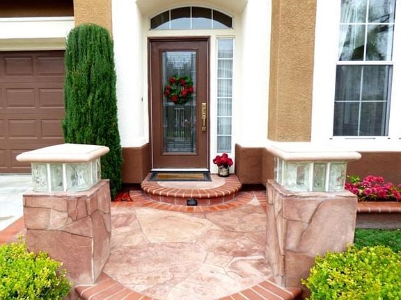 Beautiful entry with custom flagstone and brick hard scape with a lighted walkway