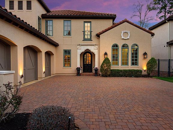 This incredible Mediterrian home has tile roof and full 3 car side by side garage.