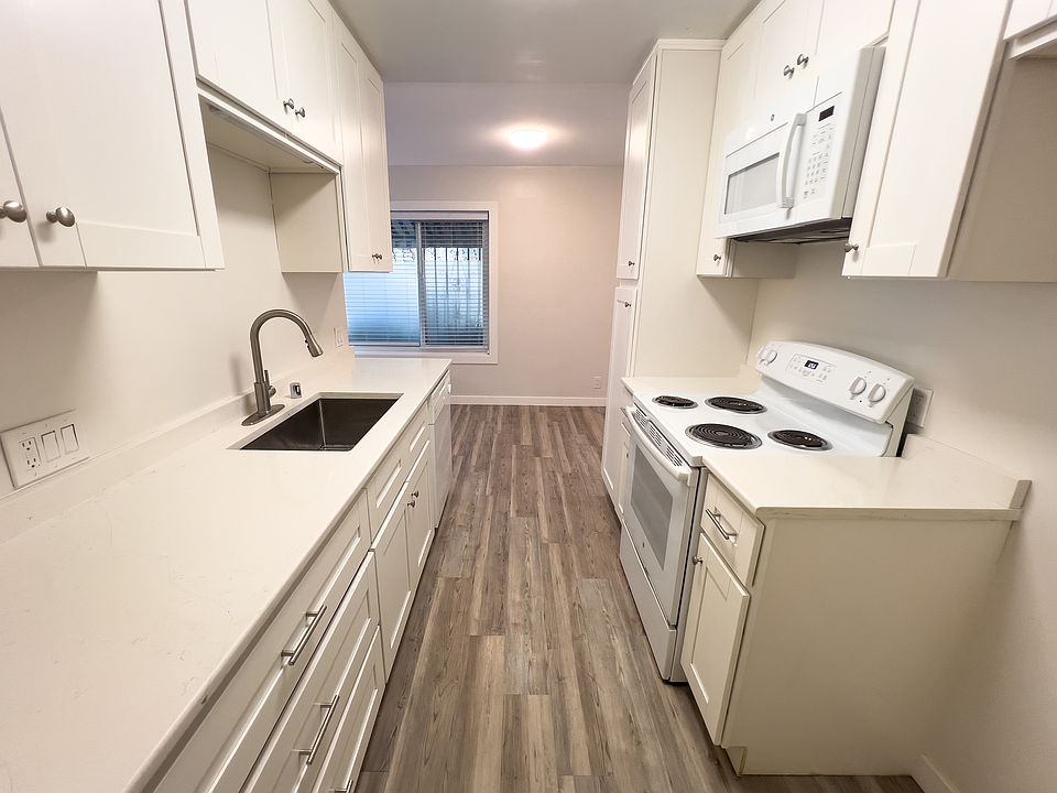 Galley style kitchen with new quartz counters. Fridge will be available.