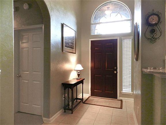 Raised ceiling and transom window grace this entry.