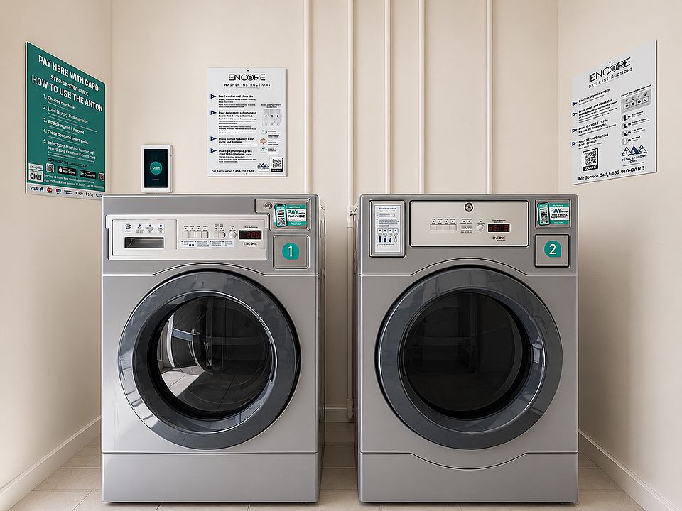 Modern laundry room with two high-efficiency washing machines, featuring convenient card payment options and clear usage instructions.
