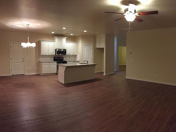 Large living room open to kitchen and dining area.