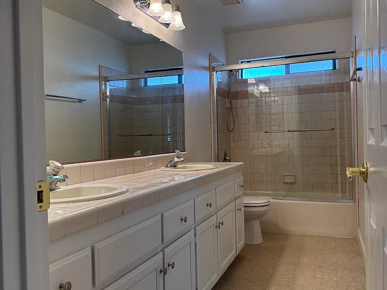Double Sink Upstairs Bathroom with 8' Counter. Direct access to Master Bedroom. Shared with Guest Bedroom