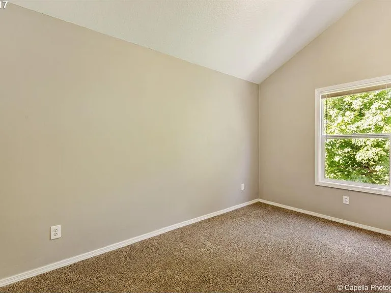 Third light filled bedroom on upper floor is light filled , airy and overlooks the green space behind the house.