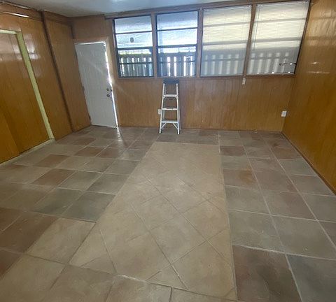 Huge bonus rm. Storage closet on left, and carport entry door is in white. All Tiled.