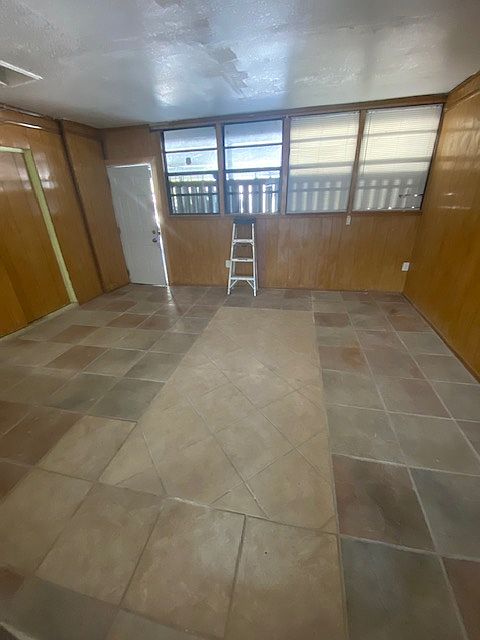 Huge bonus rm. Storage closet on left, and carport entry door is in white. All Tiled.