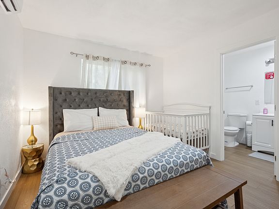 Sweet dreams for little ones in this cozy bedroom, complete with a baby crib for your peace of mind.