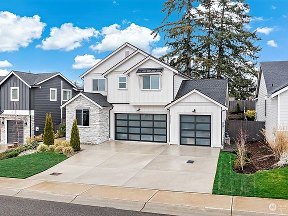 Stunning stone & metal roof accents plus tempered glass garage doors are just a few of the exterior features. The driveway offers plenty of parking with the roomy 3 car garage. Tucked in a small community and surrounded by high end homes in a prime locale that's convenient for the commuter too>