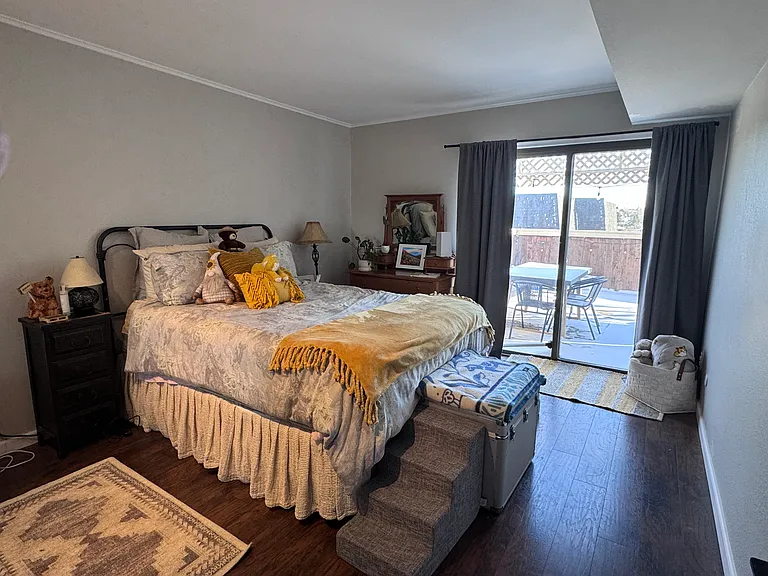 Large second bedroom with its own access to back patio. Bed shown is a queen. Closet has custom shelving.