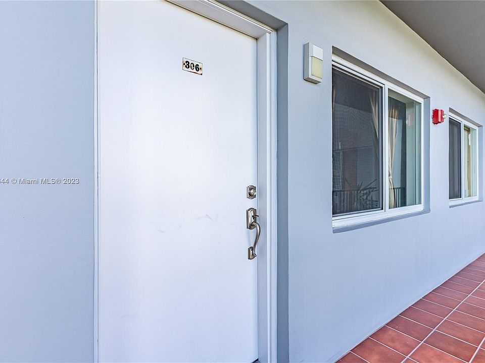 Open air hallway with window in living room and kitchen