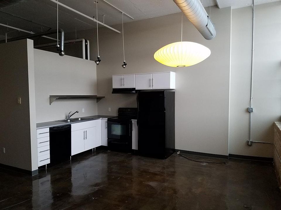 Furnished kitchen with large double sink. Additional shelving has been installed above sink.