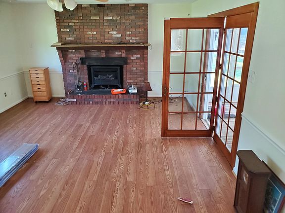 Family room with french doors leading to screened-in porch.