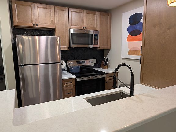 Updated kitchen cabinetry with plenty of pantry space