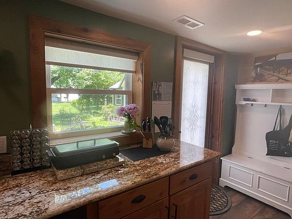 Granite counter top, convection stove top, kitchen is fully equipped. Window over looks the back yard.