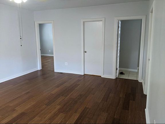 Entrance to 2 bedrooms and the bathroom at the end of the livingroom
