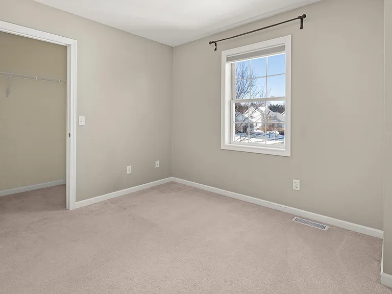 Bedroom or office with street view of the neighborhood.