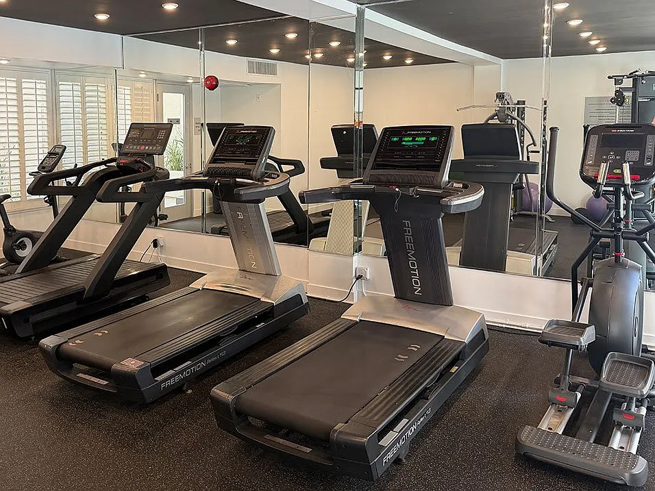 Fitness Center With Treadmills, Free Weights, and Bikes.