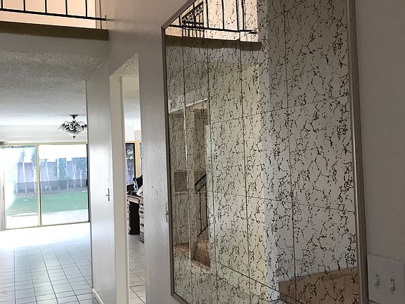 Large mirror tiles in entry