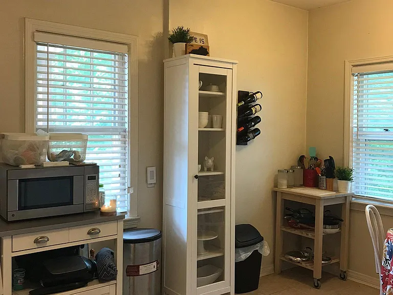 The kitchen has been repainted and includes the microwave and cabinet.