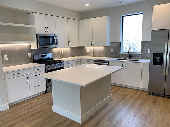 Kitchen with quartz countertops and stainless appliances