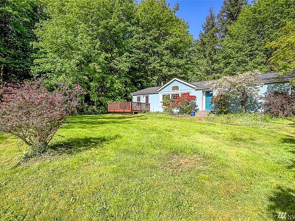 The house is tucked nicely towards the back of the lot with a wooded tree buffer behind and large sunny lawn area out front.  