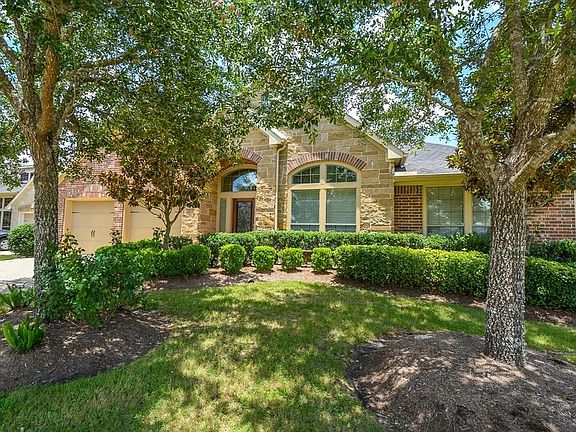 Large oak and magnolia trees and mature landscaping add to the lovely curb appeal.