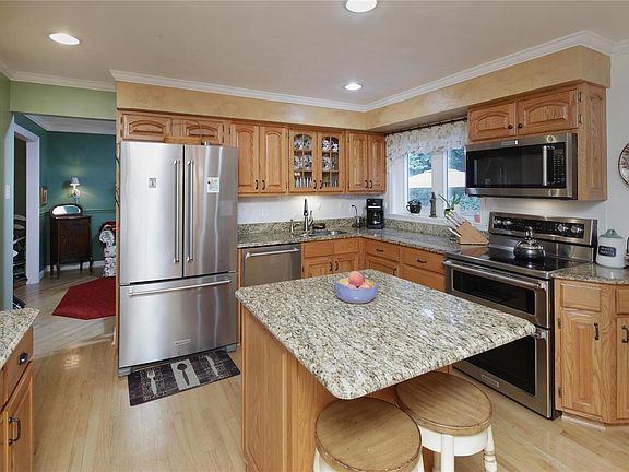 An updated kitchen with KitchenAid stainless appliances, granite counters and beautiful cabinetry.