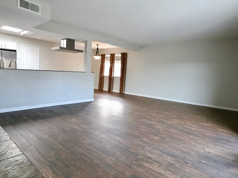 from the fireplace overlooking living room, dinning, kitchen. Patio door to the right