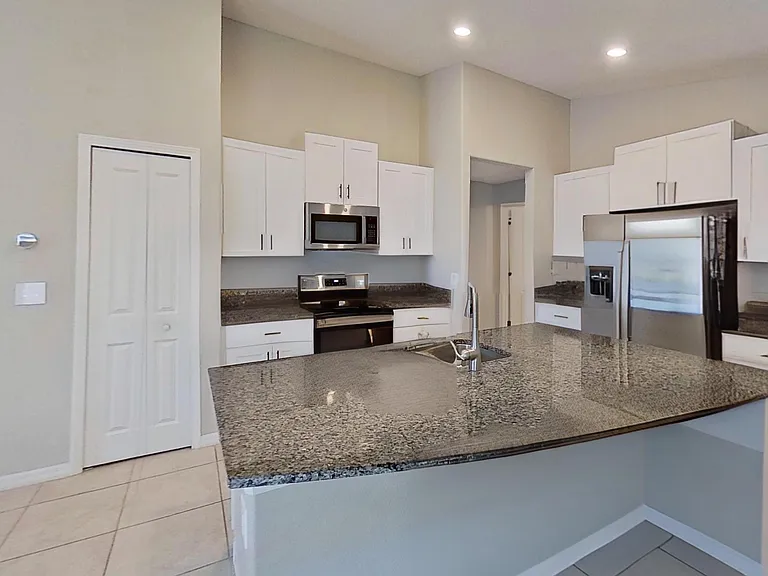 Modern kitchen with granite countertops, a spacious island, and an open layout perfect for entertaining.
