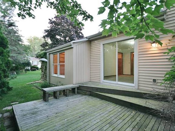 Here is a secluded area off the back sliding door. This deck has built-in seating and with a table, will be a nice place to enjoy summer dinners. 
