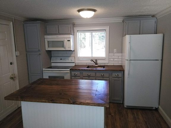 Kitchenette area, full stove and refrigerator. NO DISHWASHER, NO ICEMAKER.
