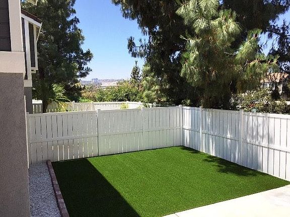 Fenced yard with artifical pet turf