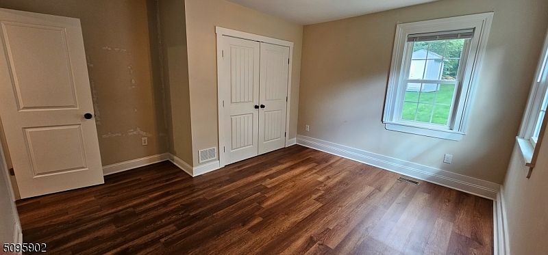 Bedroom view 2. Double door closet. 2 windows for great natural light. Room easily accommodates a queen bed & dressers.