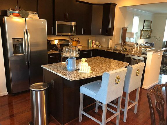 Granite Island w/ seating is part of open concept living-kitchen, dining and living room!