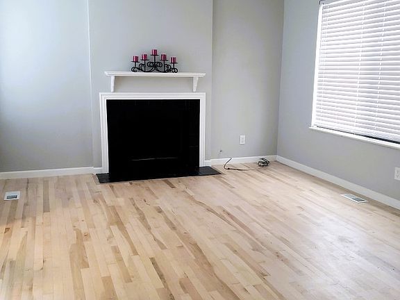 LIVING ROOM WITH WOOD BURNING FIRE PLACE