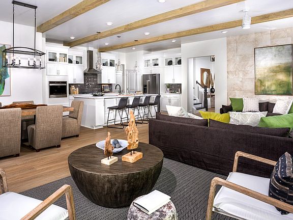 Great room and open kitchen at a DRB Homes Palm model home at the Chase Oaks community.