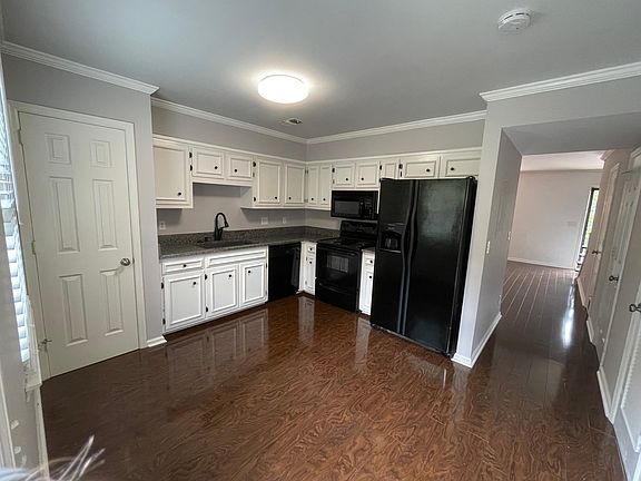 Kitchen with washer and dryer hook up includes marble counter top, dishwasher, garbage disposal, microwave and pantry.