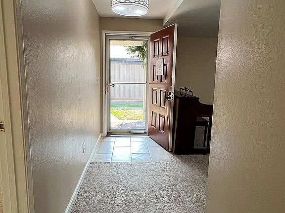 Entry way with a composite deck and covered patio