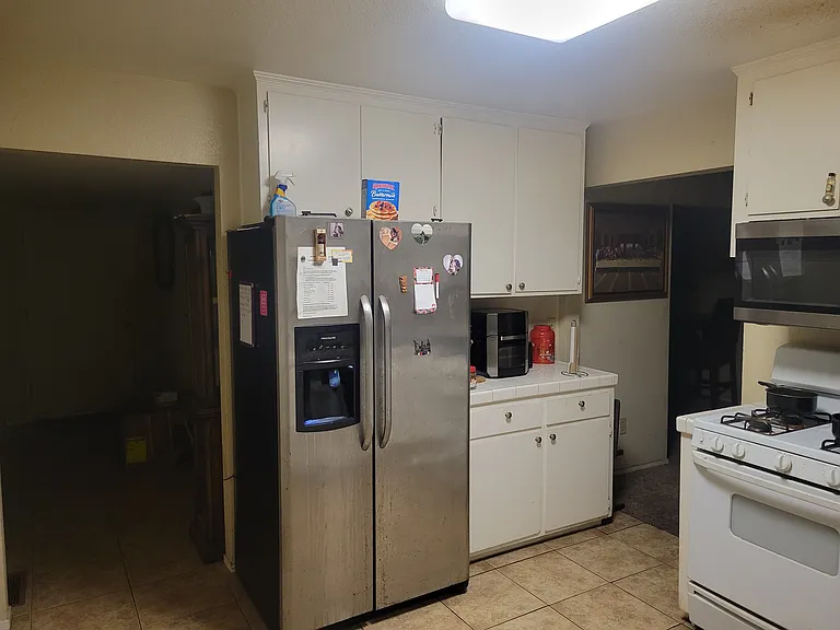 Kitchen (w) large refrigerator / freezer duo.